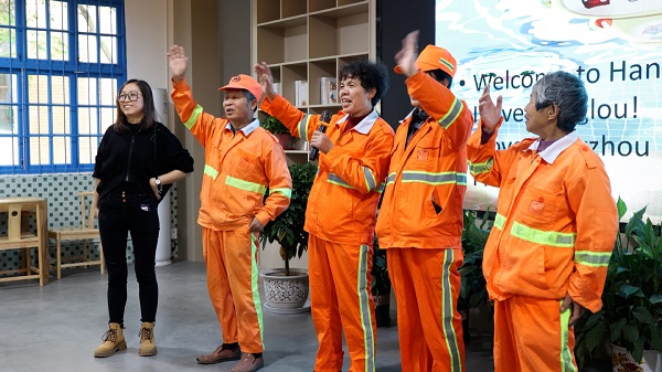 Sanitation workers learn English to cheer for Games